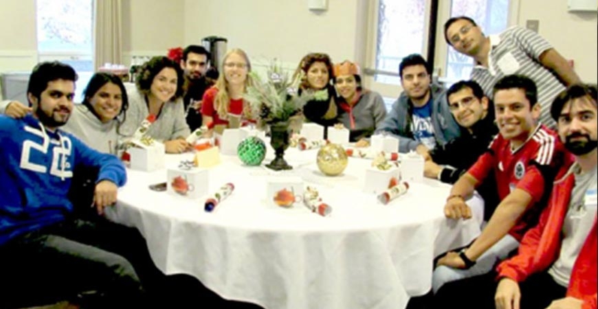 students celebrating christmas with dinner